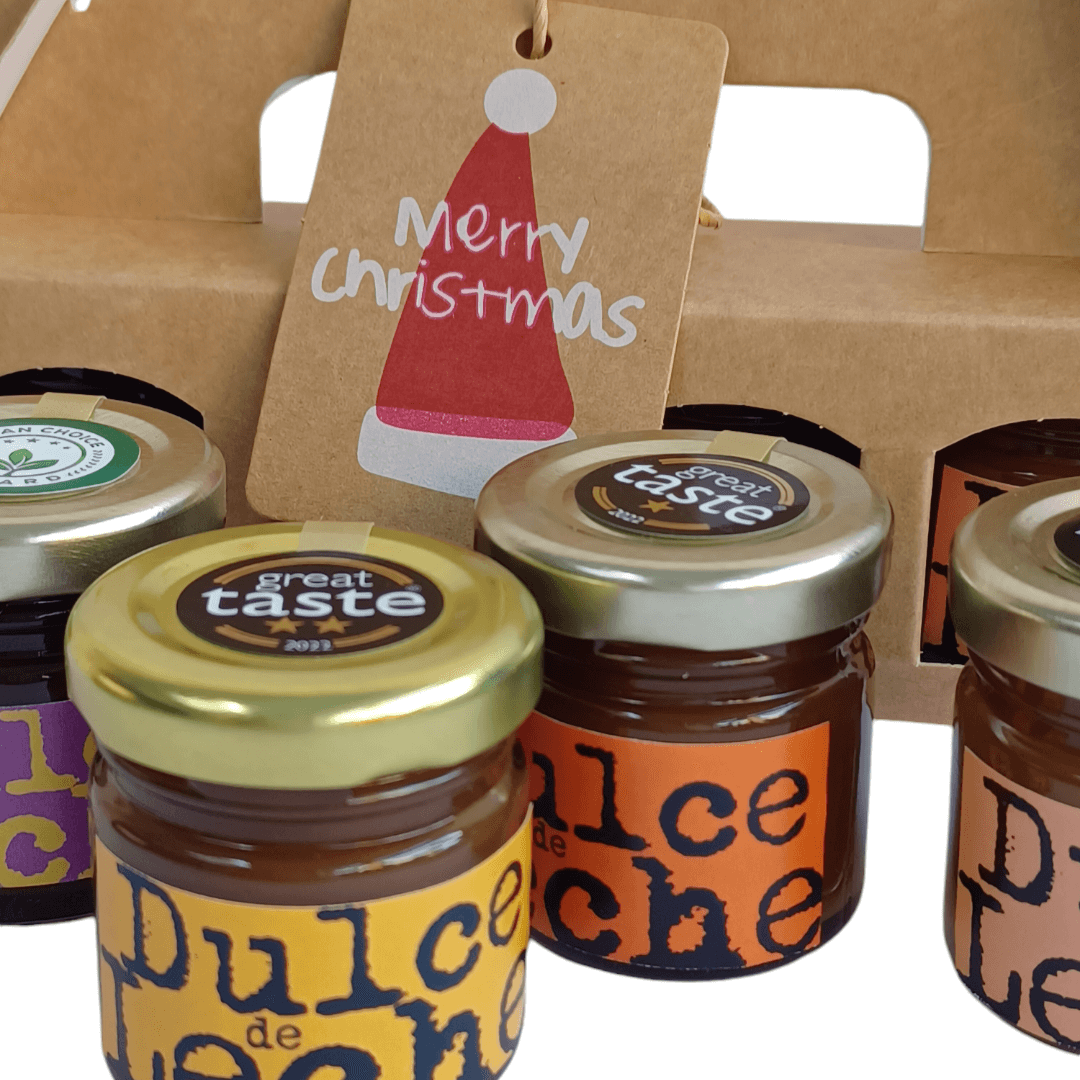 Mini Dulces gift pack with jars of Vegan Dulce de Leche, Christmas tag, and award stickers.